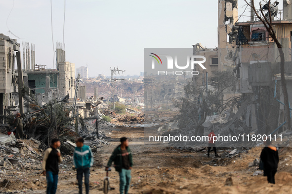 Palestinians inspect the destruction as displaced residents return to Nuseirat in the central Gaza Strip after Israeli shelling of the camp...