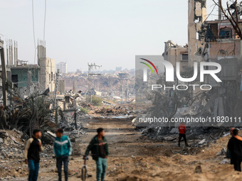 Palestinians inspect the destruction as displaced residents return to Nuseirat in the central Gaza Strip after Israeli shelling of the camp...