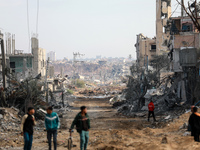 Palestinians inspect the destruction as displaced residents return to Nuseirat in the central Gaza Strip after Israeli shelling of the camp...