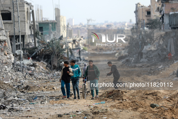 Palestinians inspect the destruction as displaced residents return to Nuseirat in the central Gaza Strip after Israeli shelling of the camp...