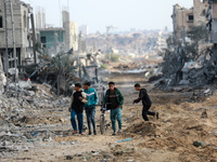 Palestinians inspect the destruction as displaced residents return to Nuseirat in the central Gaza Strip after Israeli shelling of the camp...