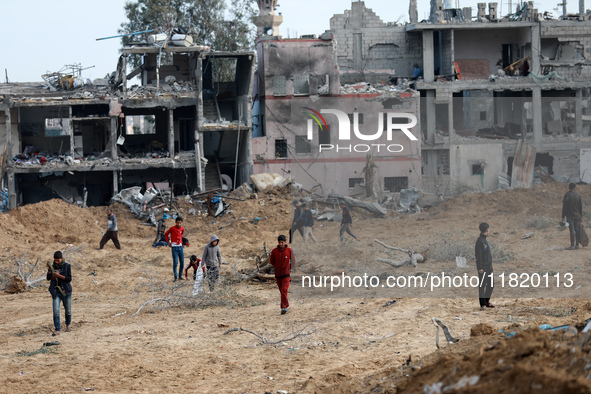 Palestinians inspect the destruction as displaced residents return to Nuseirat in the central Gaza Strip after Israeli shelling of the camp...