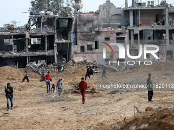 Palestinians inspect the destruction as displaced residents return to Nuseirat in the central Gaza Strip after Israeli shelling of the camp...