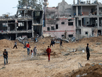 Palestinians inspect the destruction as displaced residents return to Nuseirat in the central Gaza Strip after Israeli shelling of the camp...