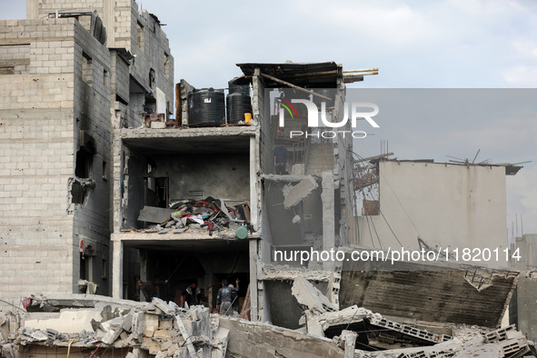 Palestinians inspect the destruction as displaced residents return to Nuseirat in the central Gaza Strip after Israeli shelling of the camp...