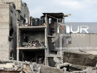 Palestinians inspect the destruction as displaced residents return to Nuseirat in the central Gaza Strip after Israeli shelling of the camp...