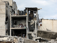 Palestinians inspect the destruction as displaced residents return to Nuseirat in the central Gaza Strip after Israeli shelling of the camp...