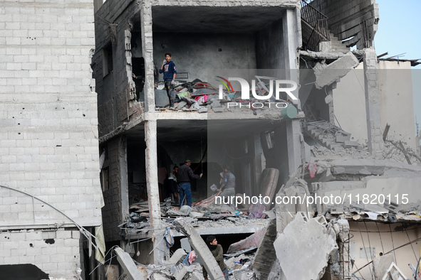 Palestinians inspect the destruction as displaced residents return to Nuseirat in the central Gaza Strip after Israeli shelling of the camp...