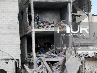 Palestinians inspect the destruction as displaced residents return to Nuseirat in the central Gaza Strip after Israeli shelling of the camp...