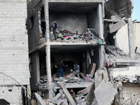 Palestinians inspect the destruction as displaced residents return to Nuseirat in the central Gaza Strip after Israeli shelling of the camp...