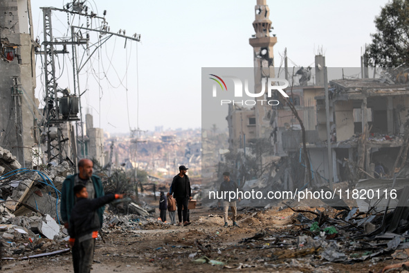 Palestinians inspect the destruction as displaced residents return to Nuseirat in the central Gaza Strip after Israeli shelling of the camp...