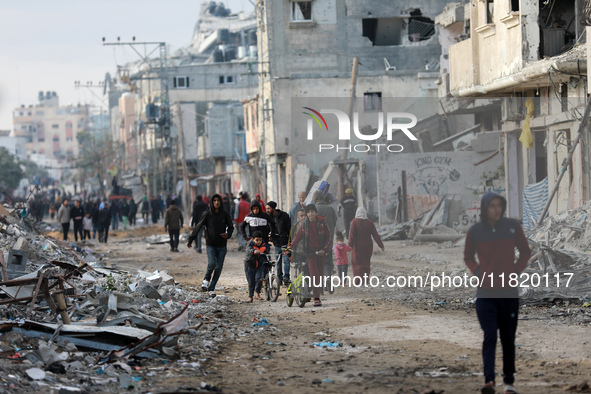 Palestinians inspect the destruction as displaced residents return to Nuseirat in the central Gaza Strip after Israeli shelling of the camp...