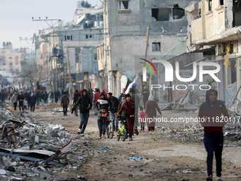 Palestinians inspect the destruction as displaced residents return to Nuseirat in the central Gaza Strip after Israeli shelling of the camp...