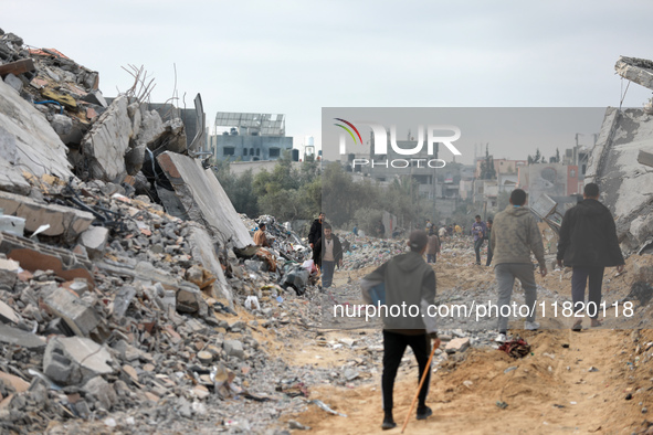 Palestinians inspect the destruction as displaced residents return to Nuseirat in the central Gaza Strip after Israeli shelling of the camp...