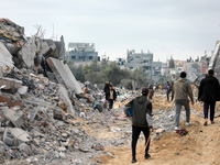 Palestinians inspect the destruction as displaced residents return to Nuseirat in the central Gaza Strip after Israeli shelling of the camp...