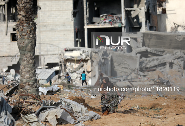 Palestinians inspect the destruction as displaced residents return to Nuseirat in the central Gaza Strip after Israeli shelling of the camp...