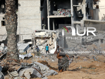 Palestinians inspect the destruction as displaced residents return to Nuseirat in the central Gaza Strip after Israeli shelling of the camp...