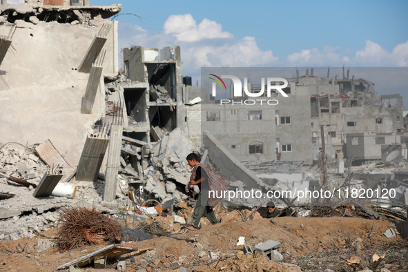 Palestinians inspect the destruction as displaced residents return to Nuseirat in the central Gaza Strip after Israeli shelling of the camp...