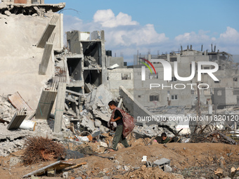 Palestinians inspect the destruction as displaced residents return to Nuseirat in the central Gaza Strip after Israeli shelling of the camp...