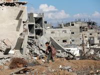 Palestinians inspect the destruction as displaced residents return to Nuseirat in the central Gaza Strip after Israeli shelling of the camp...