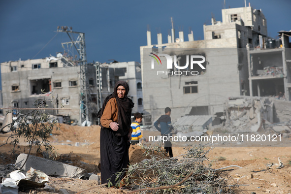 Palestinians inspect the destruction as displaced residents return to Nuseirat in the central Gaza Strip after Israeli shelling of the camp...