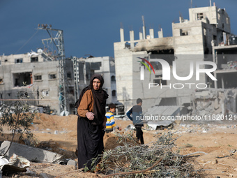 Palestinians inspect the destruction as displaced residents return to Nuseirat in the central Gaza Strip after Israeli shelling of the camp...