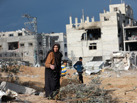 Palestinians inspect the destruction as displaced residents return to Nuseirat in the central Gaza Strip after Israeli shelling of the camp...