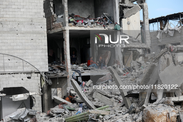 Palestinians inspect the destruction as displaced residents return to Nuseirat in the central Gaza Strip after Israeli shelling of the camp...