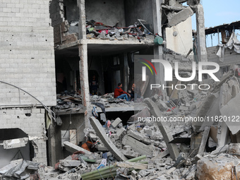 Palestinians inspect the destruction as displaced residents return to Nuseirat in the central Gaza Strip after Israeli shelling of the camp...