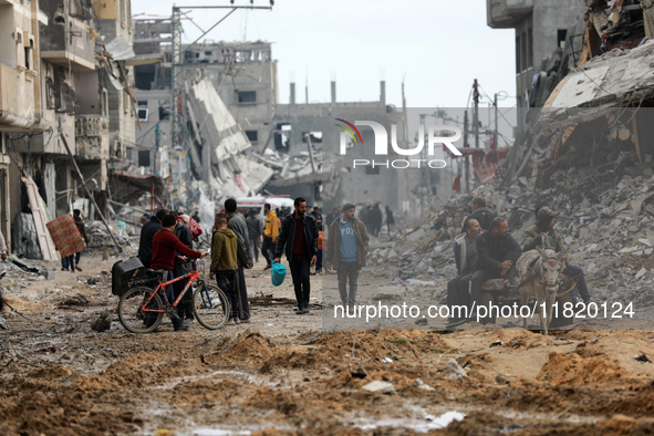 Palestinians inspect the destruction as displaced residents return to Nuseirat in the central Gaza Strip after Israeli shelling of the camp...