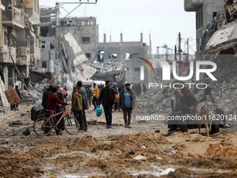 Palestinians inspect the destruction as displaced residents return to Nuseirat in the central Gaza Strip after Israeli shelling of the camp...