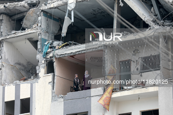 Palestinians inspect the destruction as displaced residents return to Nuseirat in the central Gaza Strip after Israeli shelling of the camp...