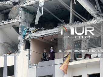 Palestinians inspect the destruction as displaced residents return to Nuseirat in the central Gaza Strip after Israeli shelling of the camp...