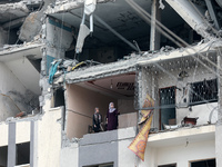 Palestinians inspect the destruction as displaced residents return to Nuseirat in the central Gaza Strip after Israeli shelling of the camp...