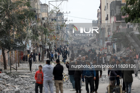 Palestinians inspect the destruction as displaced residents return to Nuseirat in the central Gaza Strip after Israeli shelling of the camp...