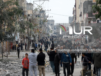 Palestinians inspect the destruction as displaced residents return to Nuseirat in the central Gaza Strip after Israeli shelling of the camp...