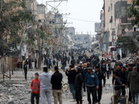 Palestinians inspect the destruction as displaced residents return to Nuseirat in the central Gaza Strip after Israeli shelling of the camp...