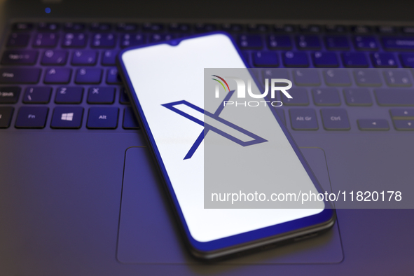 The X (Twitter) logo appears on the screen of a smartphone in Reno, United States, on November 29, 2024. 