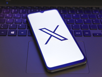 The X (Twitter) logo appears on the screen of a smartphone in Reno, United States, on November 29, 2024. (