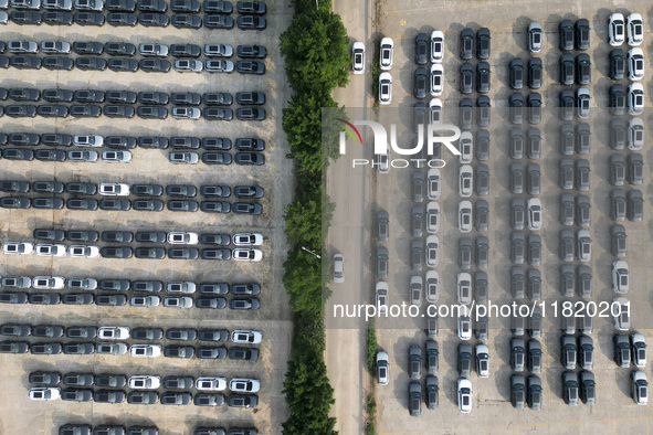 New energy vehicles park in Changansuzuki's parking lot in Chongqing, China, on November 28, 2024. 