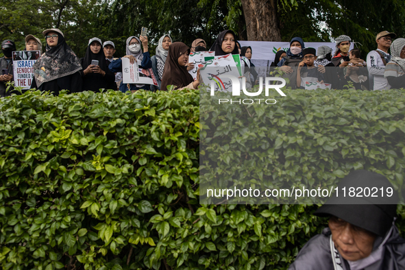 An Indonesian woman attends a rally during a pro-Palestinian demonstration in front of the US Embassy in Jakarta, Indonesia, on November 29,...