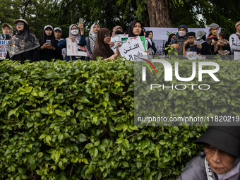 An Indonesian woman attends a rally during a pro-Palestinian demonstration in front of the US Embassy in Jakarta, Indonesia, on November 29,...