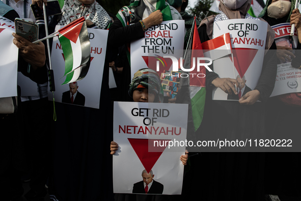 An Indonesian woman attends a rally during a pro-Palestinian demonstration in front of the US Embassy in Jakarta, Indonesia, on November 29,...