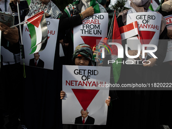 An Indonesian woman attends a rally during a pro-Palestinian demonstration in front of the US Embassy in Jakarta, Indonesia, on November 29,...