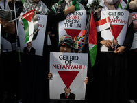 An Indonesian woman attends a rally during a pro-Palestinian demonstration in front of the US Embassy in Jakarta, Indonesia, on November 29,...