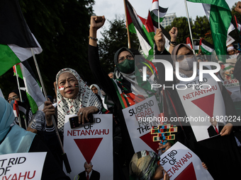 Indonesian people shout slogans and hold placards during a pro-Palestinian demonstration in front of the US Embassy in Jakarta, Indonesia, o...