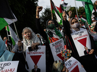 Indonesian people shout slogans and hold placards during a pro-Palestinian demonstration in front of the US Embassy in Jakarta, Indonesia, o...