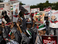 Indonesian people shout slogans and hold placards during a pro-Palestinian demonstration in front of the US Embassy in Jakarta, Indonesia, o...