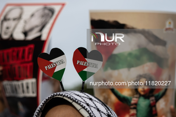 Indonesian people shout slogans and hold placards during a pro-Palestinian demonstration in front of the US Embassy in Jakarta, Indonesia, o...