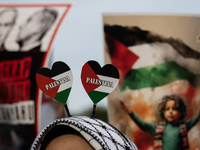 Indonesian people shout slogans and hold placards during a pro-Palestinian demonstration in front of the US Embassy in Jakarta, Indonesia, o...